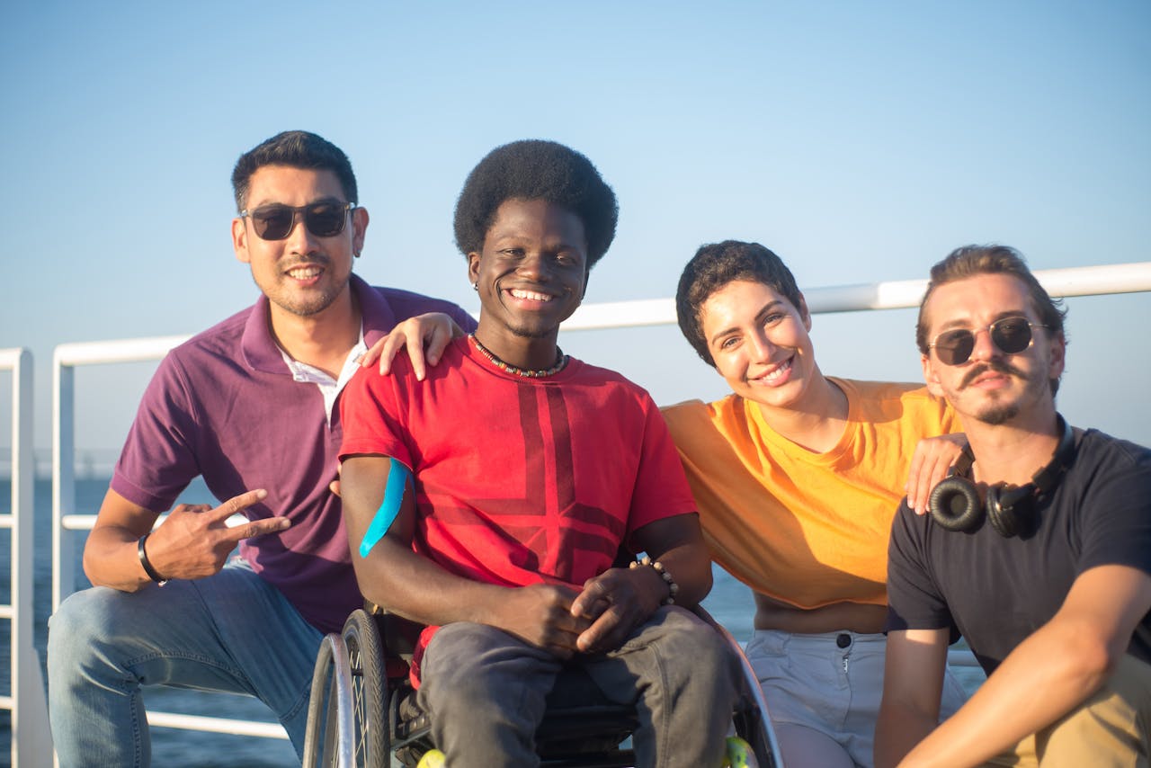 A diverse group of friends, including a person in a wheelchair, enjoying quality time outdoors in Portugal.
